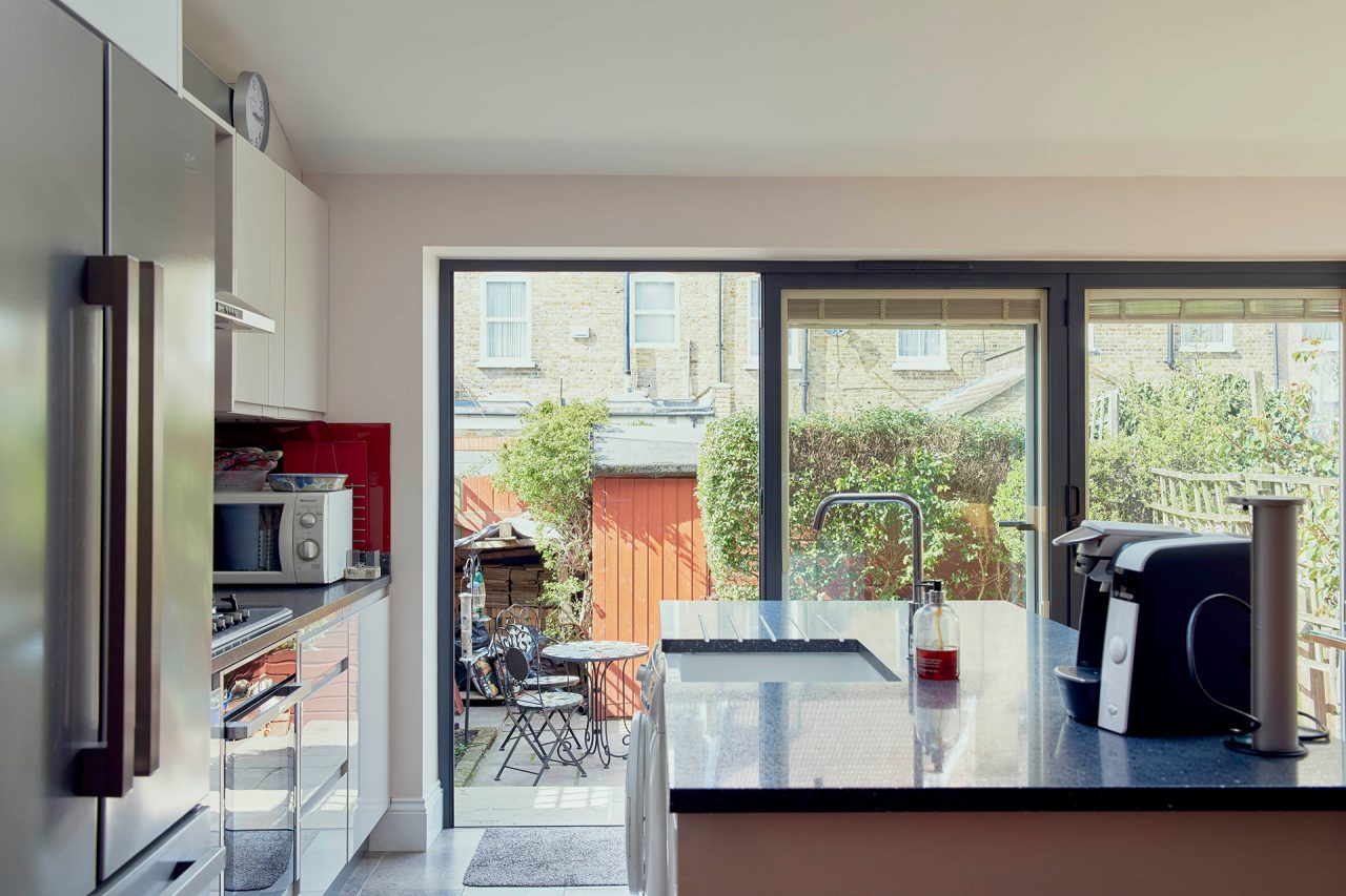 The new kitchen looks out onto the patio through bi-folding doors