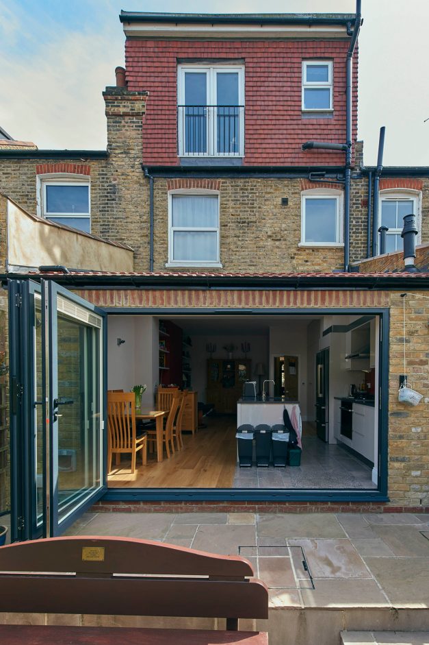 The exterior of the house with the bi-fold doors open